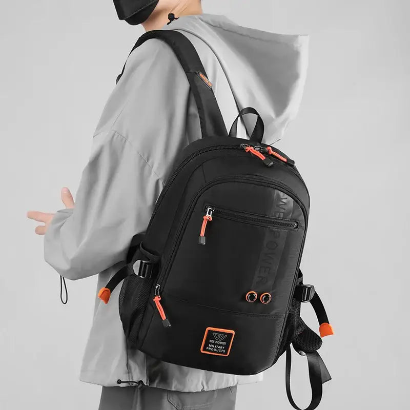 Black backpack with orange accents and zippered compartments, made of quality nylon fabric