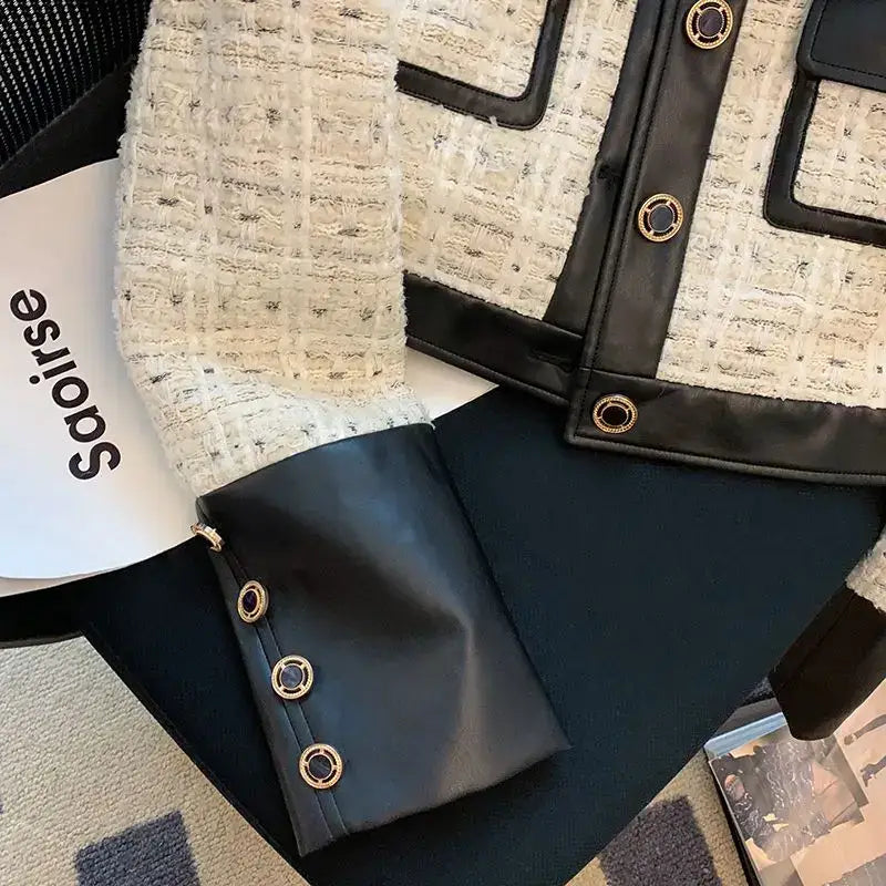 Black leather bag with metallic grommets, perfect for pairing with lapel single-breasted coats