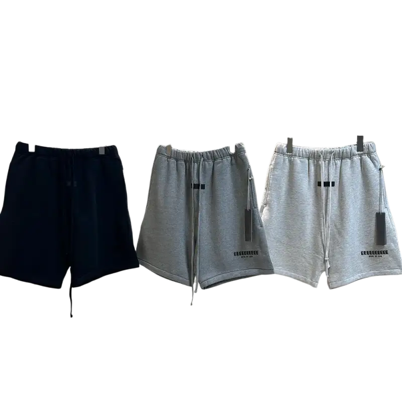 Three pairs of navy blue and gray jogger shorts with drawstrings on rack