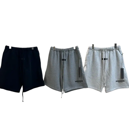 Three pairs of navy blue and gray jogger shorts with drawstrings on rack