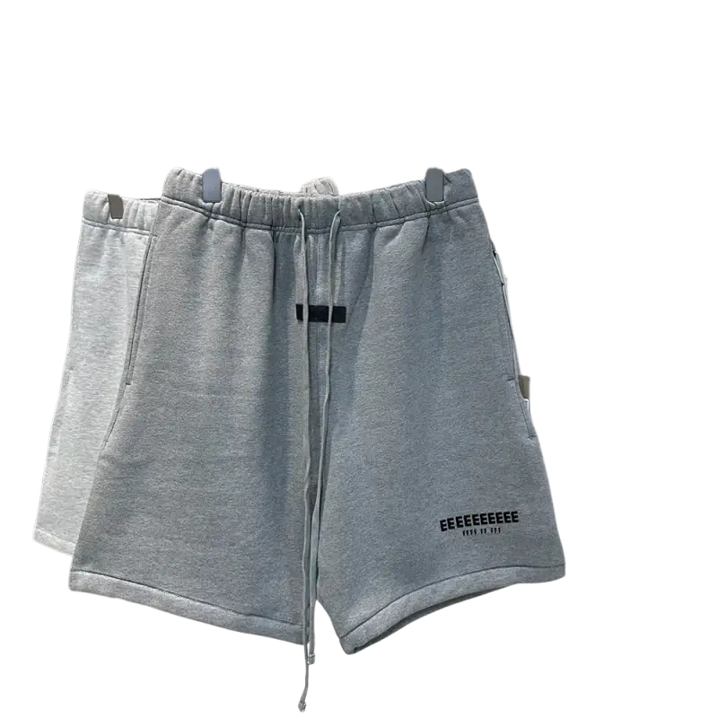 Light gray hip hop jogger shorts with black drawstring on rack
