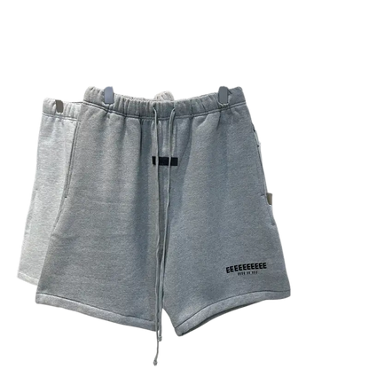 Light gray hip hop jogger shorts with black drawstring on rack