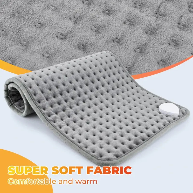 Gray textured dimpled surface of a dark grey electric heating blanket for sofa bed