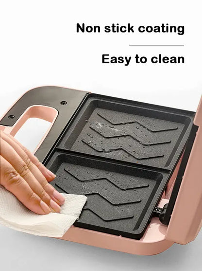 Non-stick Electric Panini Sandwich Machine with textured grill plates being cleaned