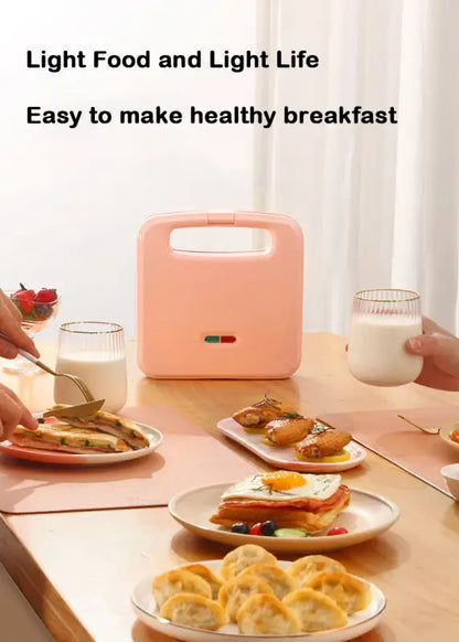 Pink Electric Panini Sandwich Machine multifunction on a dining table with prepared food