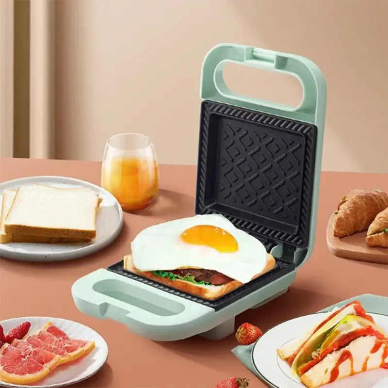 Mint green sandwich maker panini press with waffle textured surface and non-stick coating