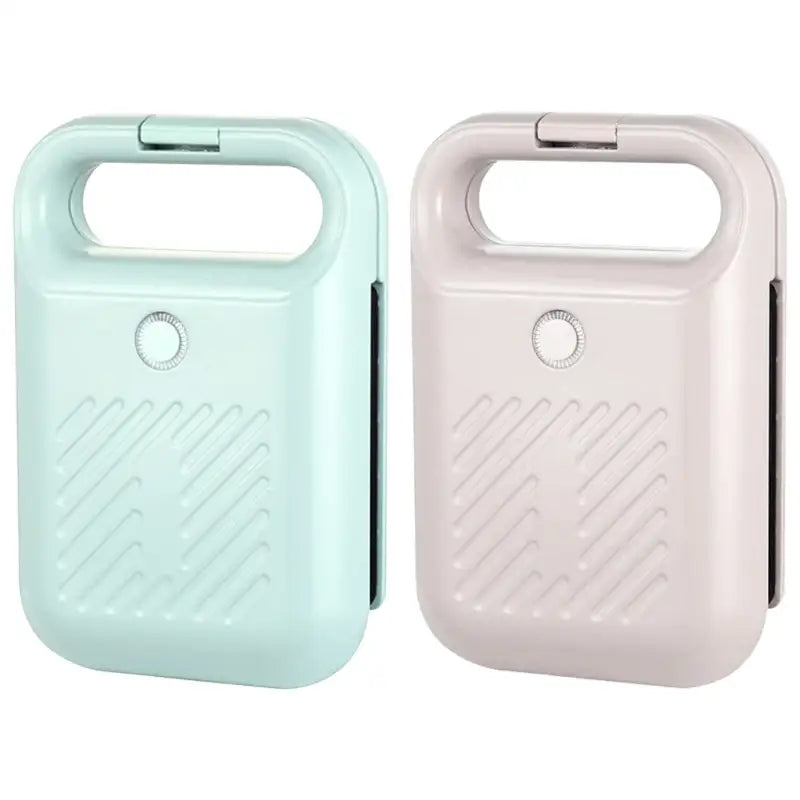 Portable handheld fans in mint green and beige near a Sandwich Maker Panini Press