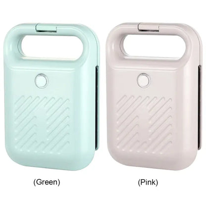 Two portable hand warmers in mint green and light pink near a Panini Press