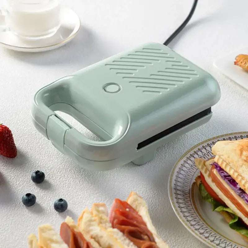 Mint green sandwich maker panini with ridged surface and non-stick coating for egg omelettes