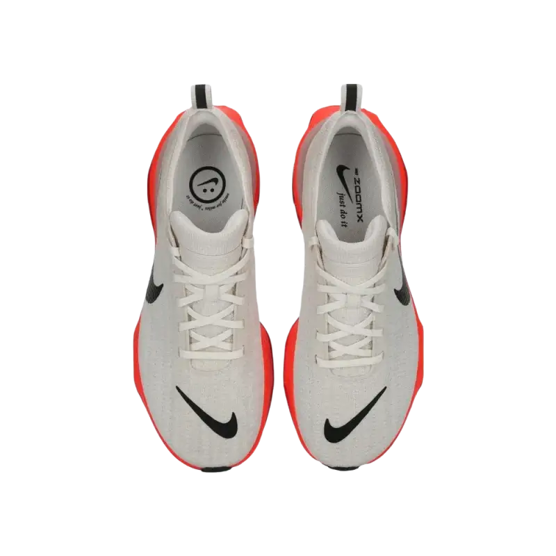 White and orange Nike running shoe with black swoosh and cushioned support